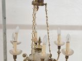 a chandelier that has five lights hanging from it