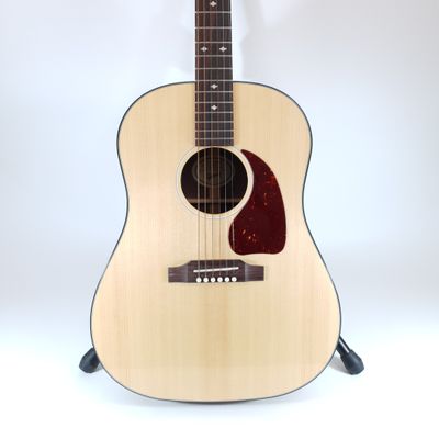 a close up of a guitar on a stand against a white background