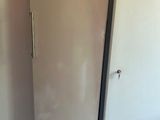 two refrigerators in the corner of a room