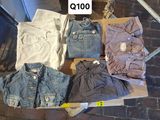 a lot of clothes that are sitting on a table