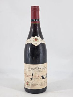 a close up of a bottle of wine on a white surface