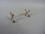 pair of silver plated earrings on a white surface