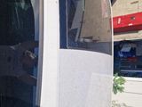 a man taking a picture of himself in the mirror of a car