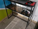 a laptop computer sitting on top of a glass desk
