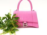pink handbag with flowers on white background with copy space for text