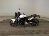 a white and blue motorcycle parked in a garage