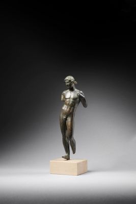 a bronze statue of a man standing on a pedestal