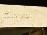 a silver plate with writing on it sitting on top of a table