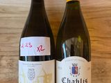 two bottles of wine that are sitting on a shelf