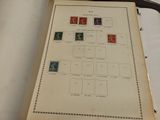 an old book with stamps on it sitting on a table