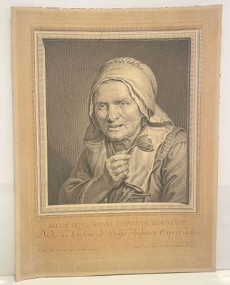an old picture of an old woman with a scarf on her head