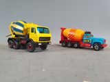 two toy trucks that are next to each other on a table