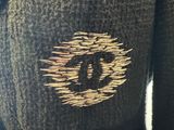 a knitted sweater with a gold eye on it