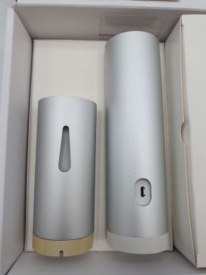 a white box with two silver cylinders in it