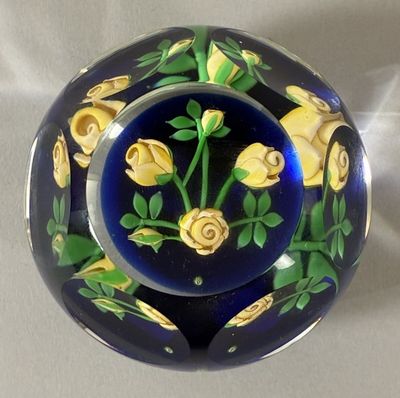 a blue and yellow plate with yellow roses on it