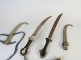 several different types of knives are displayed on a white surface