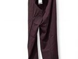 purple pants hanging on a hanger on a white wall
