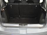 the back of a car with its trunk open and luggage in the trunk