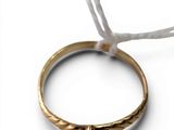 a close up of a gold ring with a red stone on it