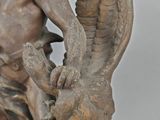 a statue of a man with a bird on his shoulder