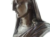 a bronze statue of a woman with a crown on her head