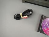 a cable that is connected to a cd on a table