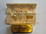 an old gold bar sitting on top of a piece of paper