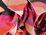 a close up of a scarf with a design on it
