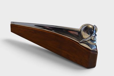 a wooden and metal object on a white surface