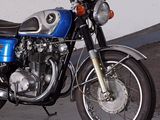 a blue motorcycle that is parked in a garage