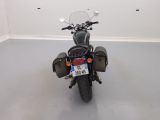 a motorcycle parked in a room with a number plate on the back