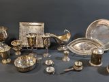 a table with a lot of silver items on it