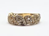 a close up of a gold ring with diamonds on a white background