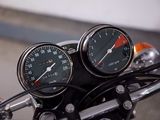 two speedometers on the handlebars of a motorcycle