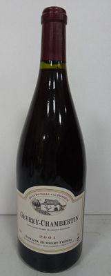a bottle of wine sitting on a table next to a bottle of wine