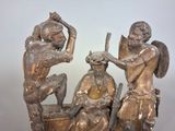 a statue of three people sitting on a boat