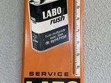 an orange sign with a thermometer on it hanging on a wall