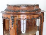 a wooden cabinet with a glass door and a shelf