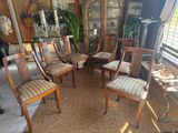 a room with a lot of chairs and a table in it