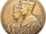 an image of a gold medal with a queen and a crown on it