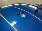 a remote control sitting on top of a blue car