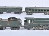four toy trains sitting on a white surface