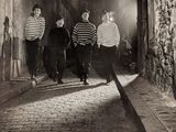 black and white photograph of a group of young men walking down a street