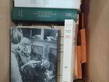 many books in a cardboard box on the table