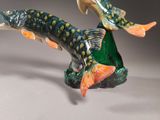 a figurine of a fish and a fish on a rock