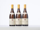 three bottles of wine sitting on top of a white table