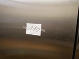a sticker on the door of a stainless steel refrigerator