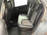 the back seats of a silver car are empty in the car