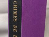a purple book sitting on top of a white cloth covered table
