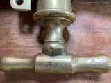 a close up of a brass faucet on a wooden table